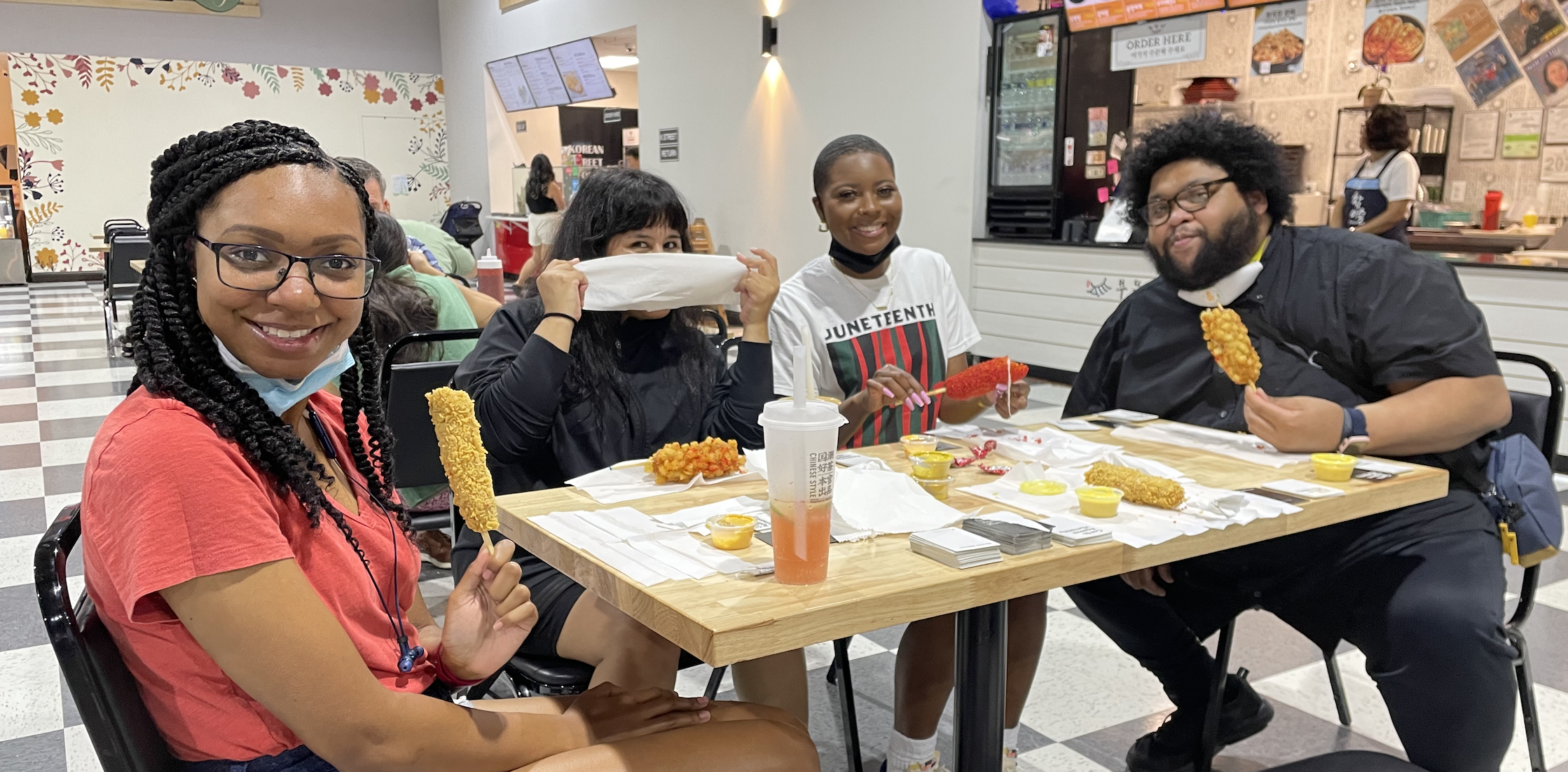 Our team of BIPOC designers enjoying Korean corn dogs in a grocery foodcourt.