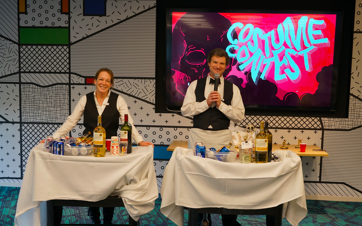 Our two fearless leaders dressed up as bartenders, smiling at the camera.